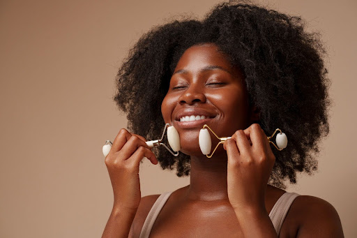 Portrait of a black woman doing facials to have clear and glowing skin Portrait of a black woman doing facials to have clear and glowing skin